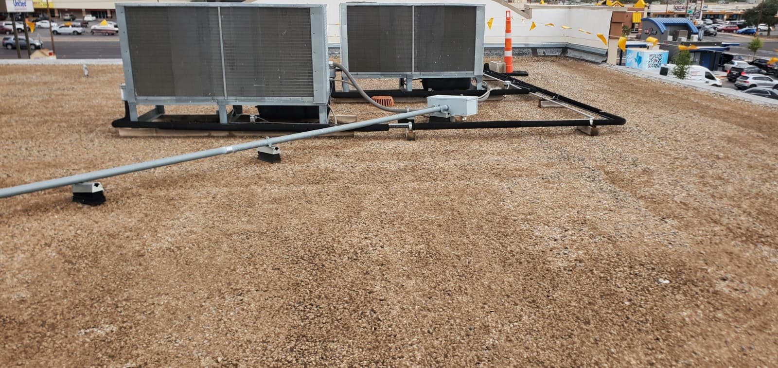 Commercial flat roof during pea gravel removal with roof vacuum equipment